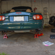 Up on the jack stands. Note the well-used shop manual. Purple post-its denote the pages describing brake pad changes and changing the rear differential oil.